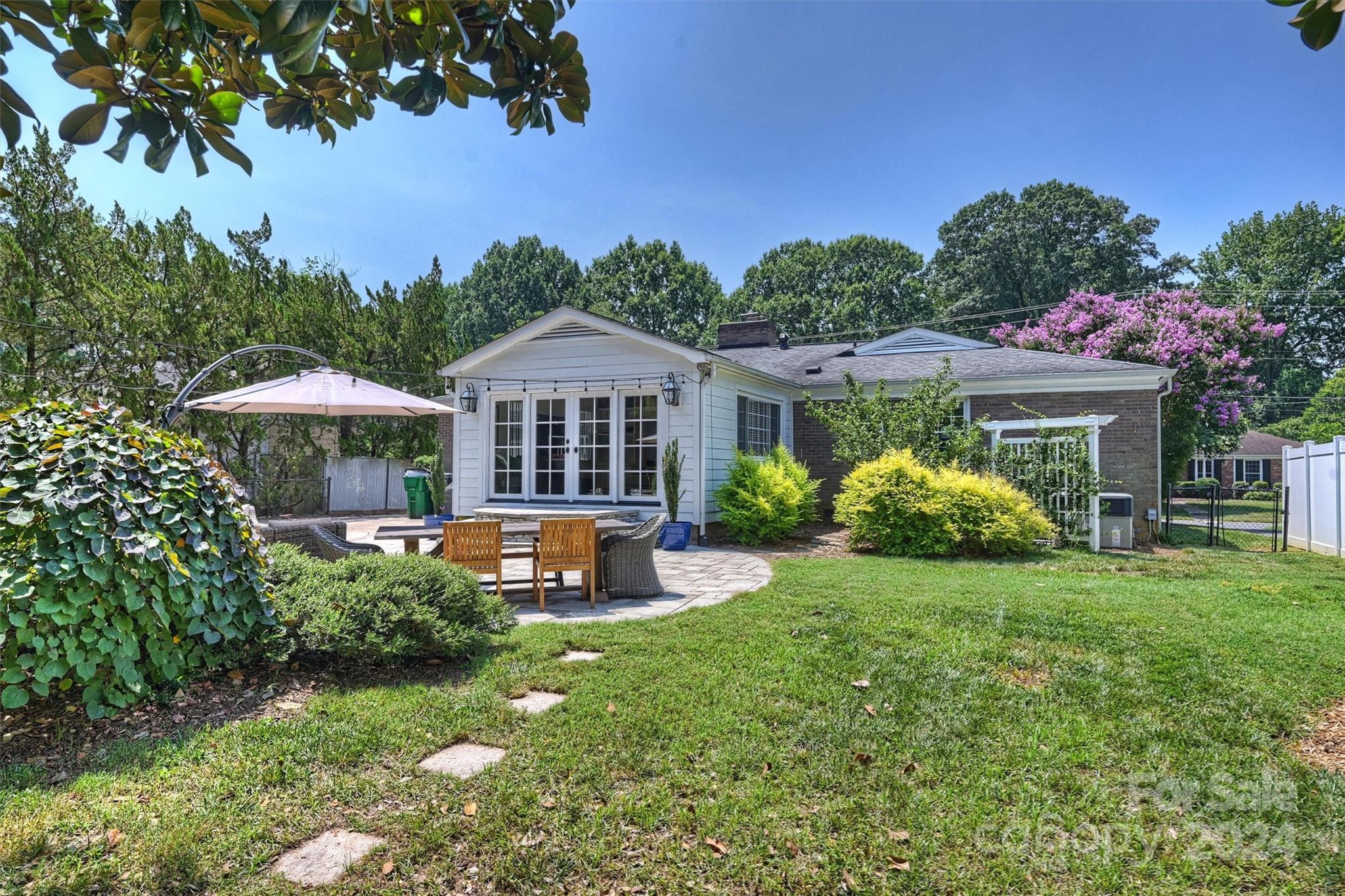 4115 Sulkirk Road Charlotte, NC 28210 - Photo 34 of 39 a front view of a house with a yard fire pit table and chairs