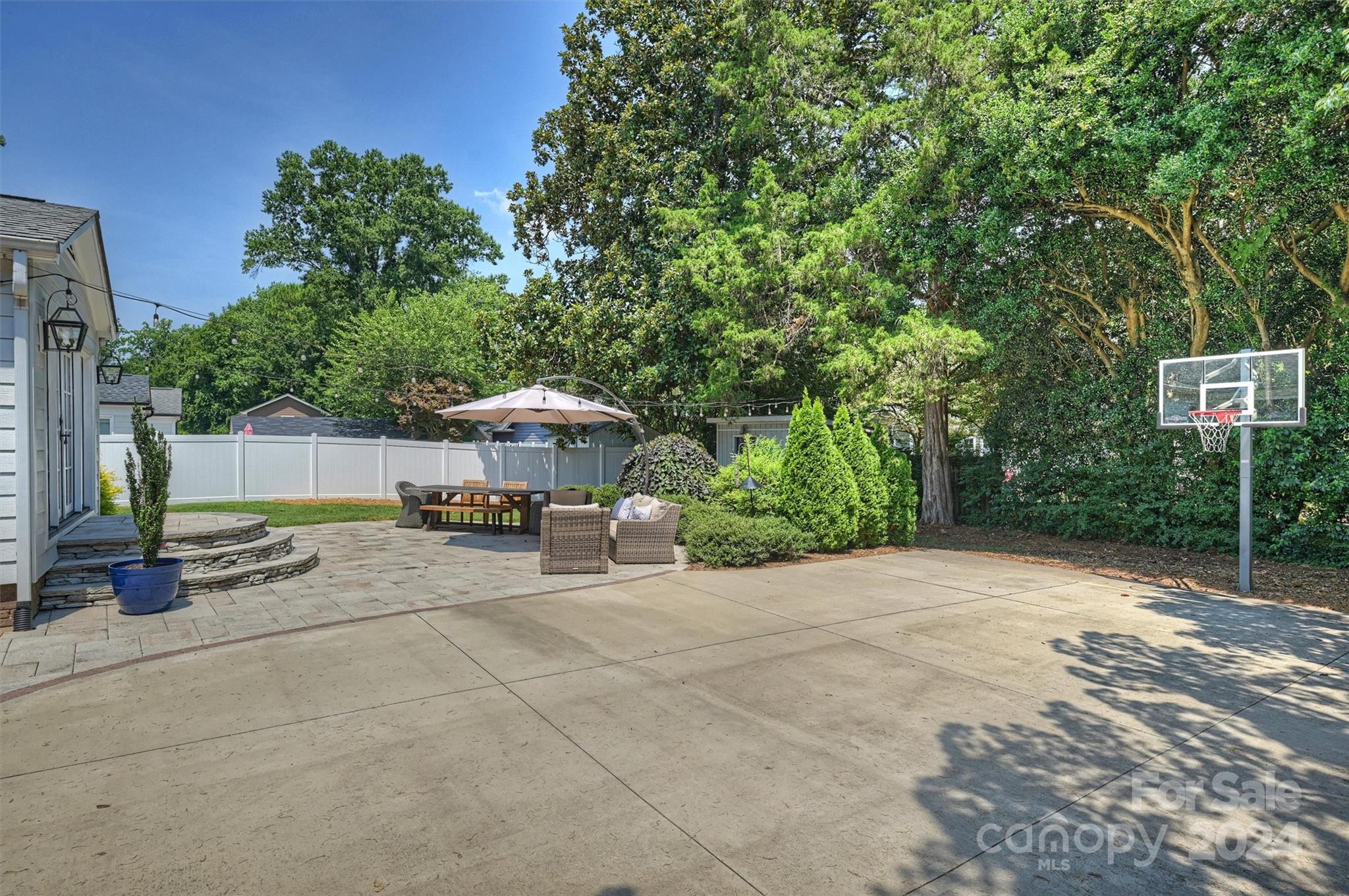 4115 Sulkirk Road Charlotte, NC 28210 - Photo 36 of 39 a view of a patio with table and chairs under an umbrella