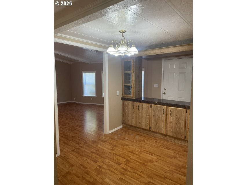 5660 Daisy Street, Unit 31 Springfield, OR 97478 - Photo 41 of 44 a view of a hallway with wooden floor