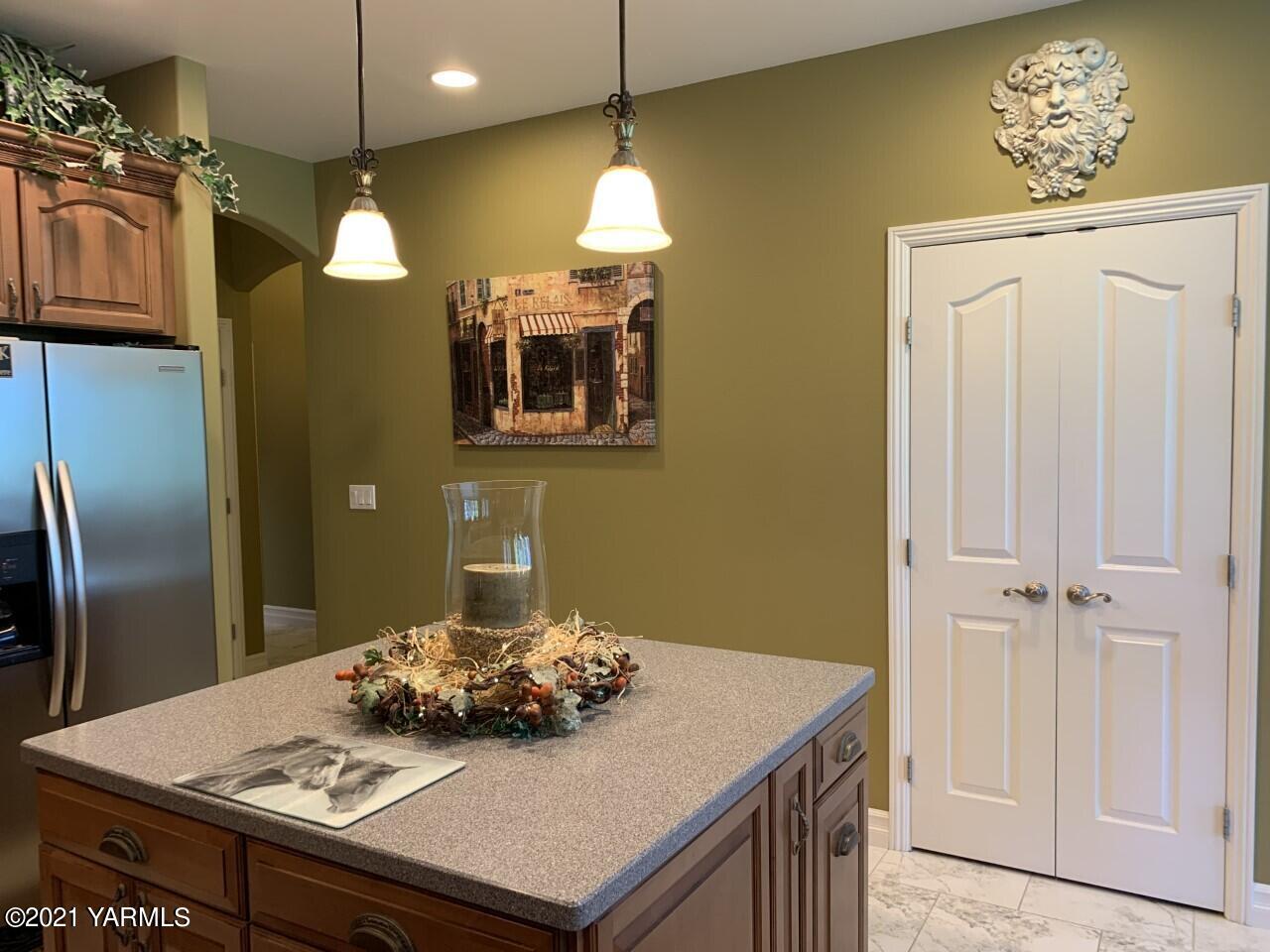 14841 Fisk Road Yakima, WA 98908 - Photo 42 of 59 a kitchen with a table chairs and refrigerator