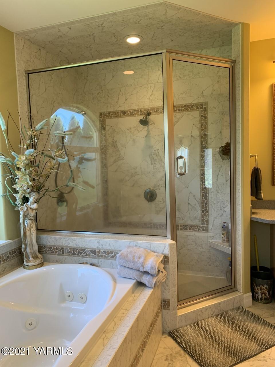 14841 Fisk Road Yakima, WA 98908 - Photo 46 of 59 a bathroom with a tub and a shower