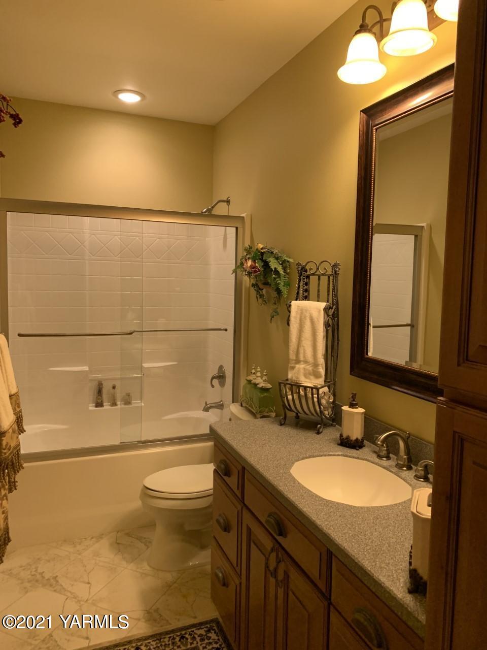 14841 Fisk Road Yakima, WA 98908 - Photo 10 of 59 a bathroom with a sink a toilet and shower