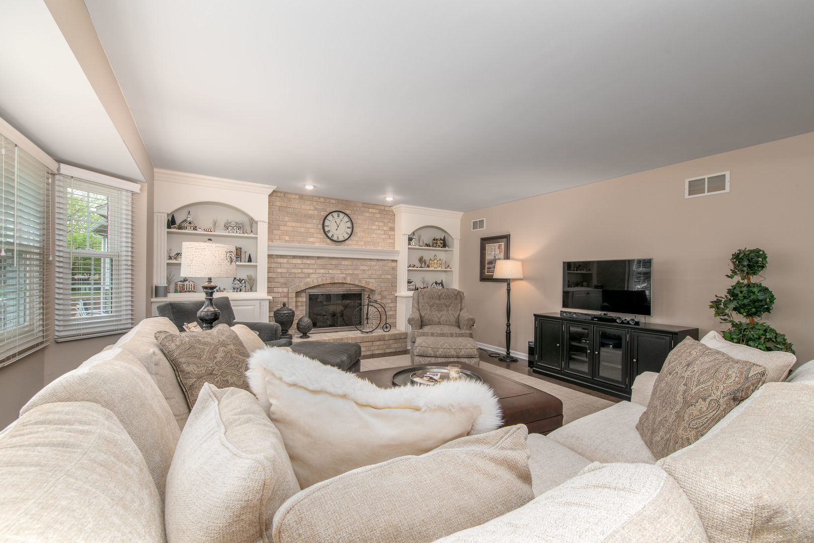 1608 Grommon Road Naperville, IL 60564 - Photo 9 of 48 a living room with furniture a large window and a fireplace