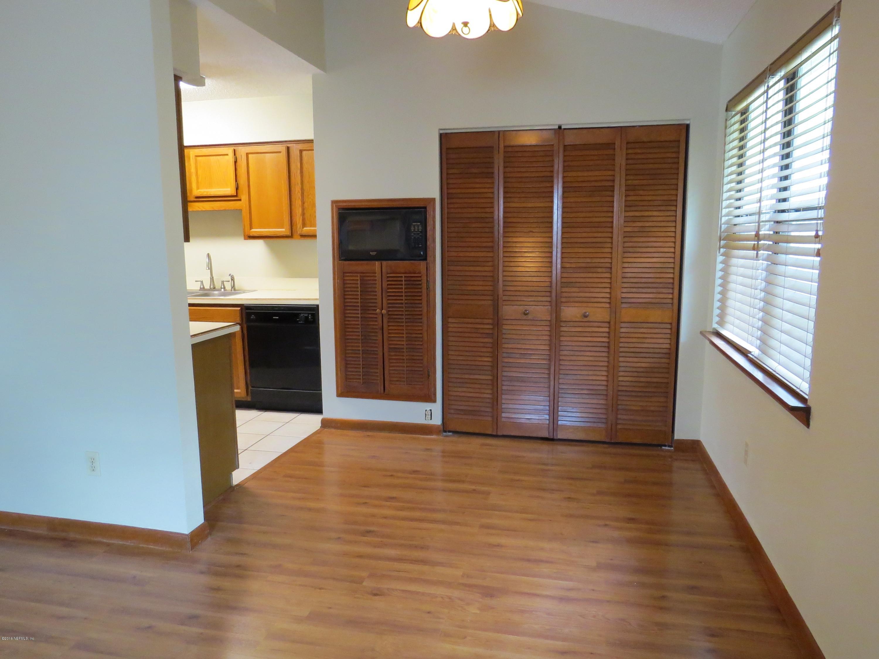 12770 Beaubien Road Jacksonville, FL 32258 - Photo 12 of 46 an empty room with wooden floor and entrance