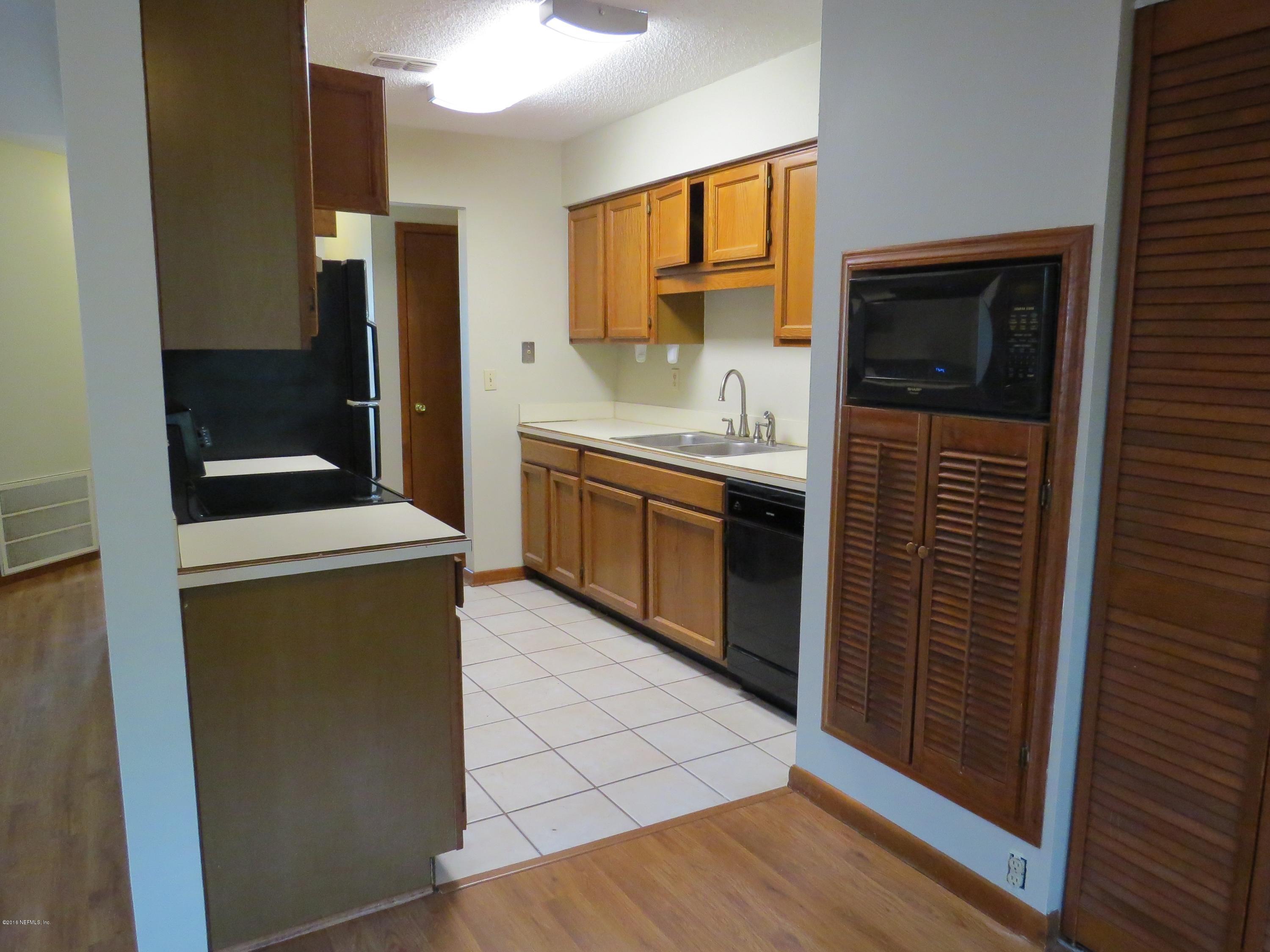 12770 Beaubien Road Jacksonville, FL 32258 - Photo 13 of 46 a kitchen with stainless steel appliances a stove a sink and a refrigerator