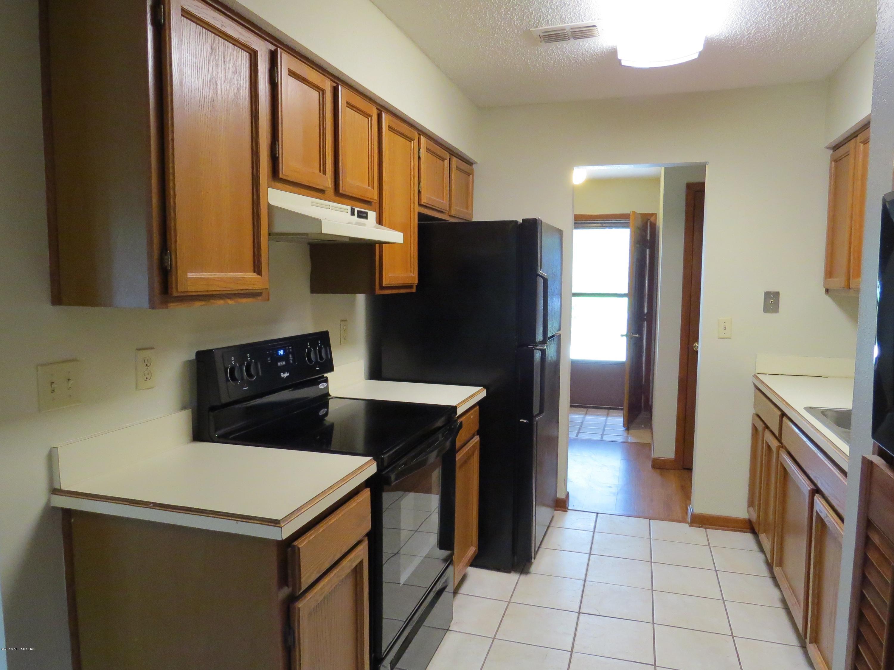 12770 Beaubien Road Jacksonville, FL 32258 - Photo 14 of 46 a kitchen with stainless steel appliances granite countertop a refrigerator a stove and a sink