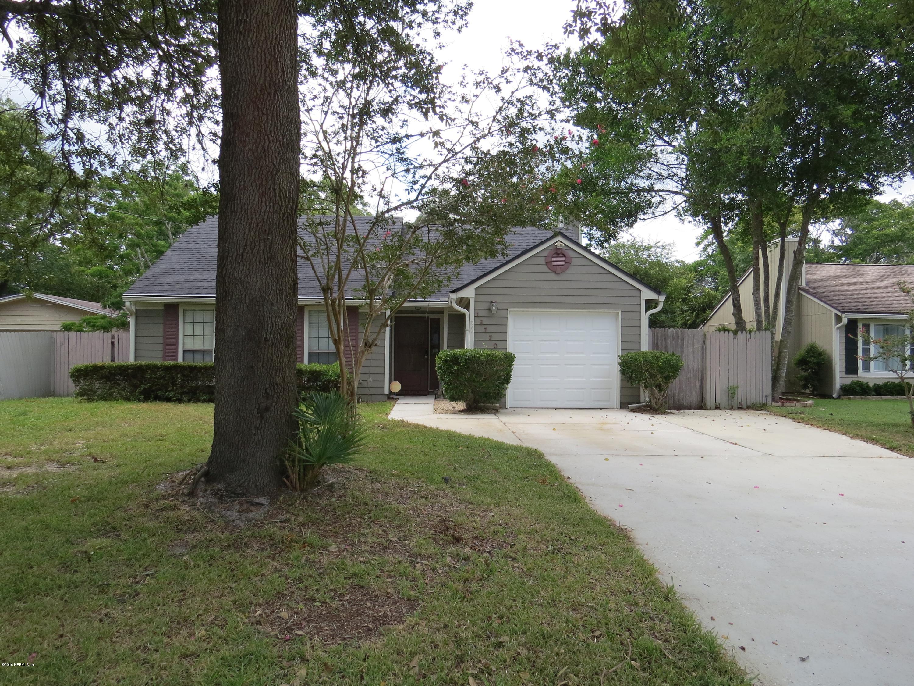 12770 Beaubien Road Jacksonville, FL 32258 - Photo 3 of 46 a front view of a house with a yard and garage