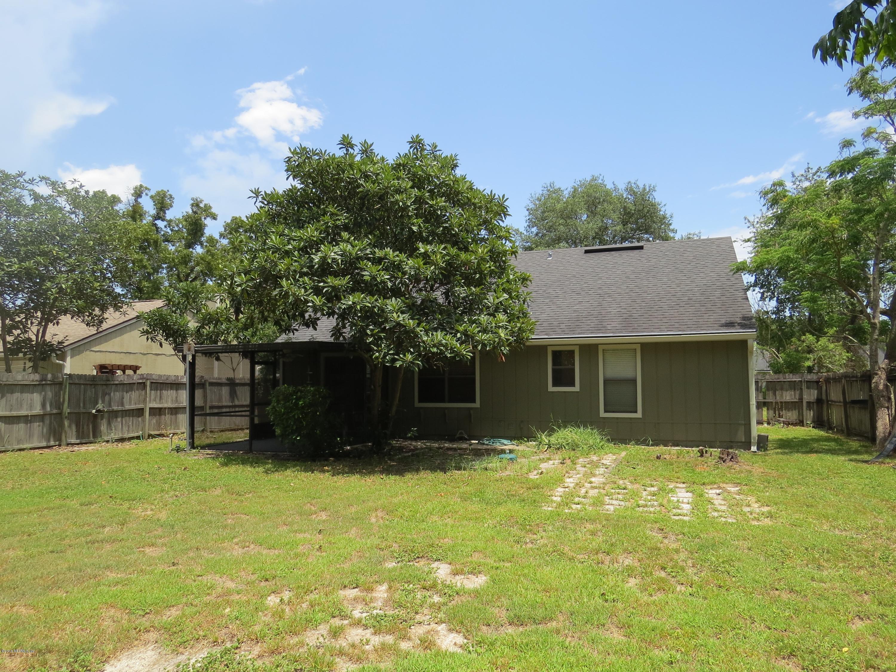 12770 Beaubien Road Jacksonville, FL 32258 - Photo 37 of 46 a front view of house with yard and trees in the background
