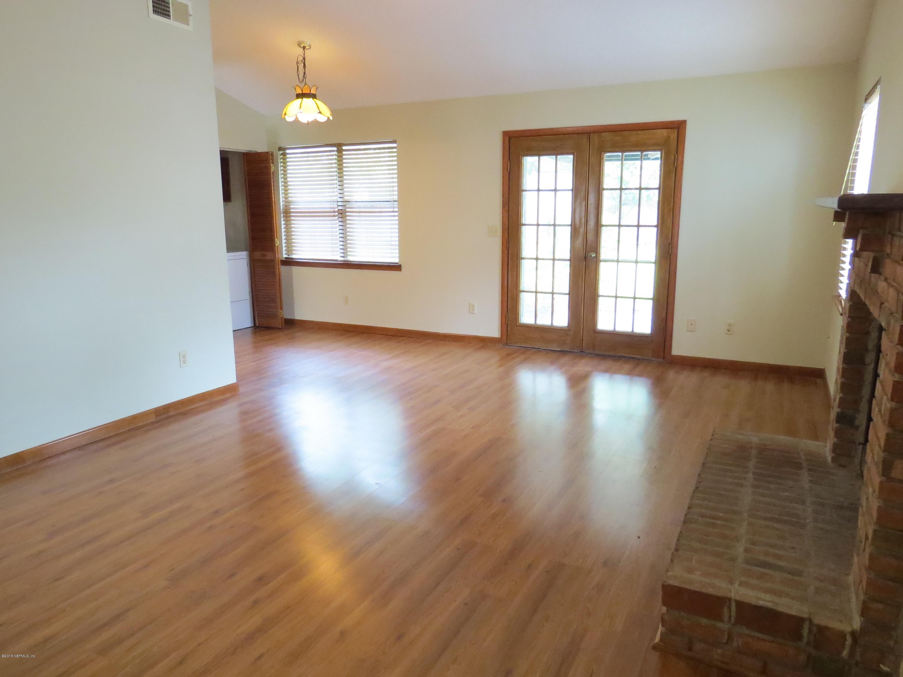 12770 Beaubien Road Jacksonville, FL 32258 - Photo 9 of 46 an empty room with wooden floor and windows