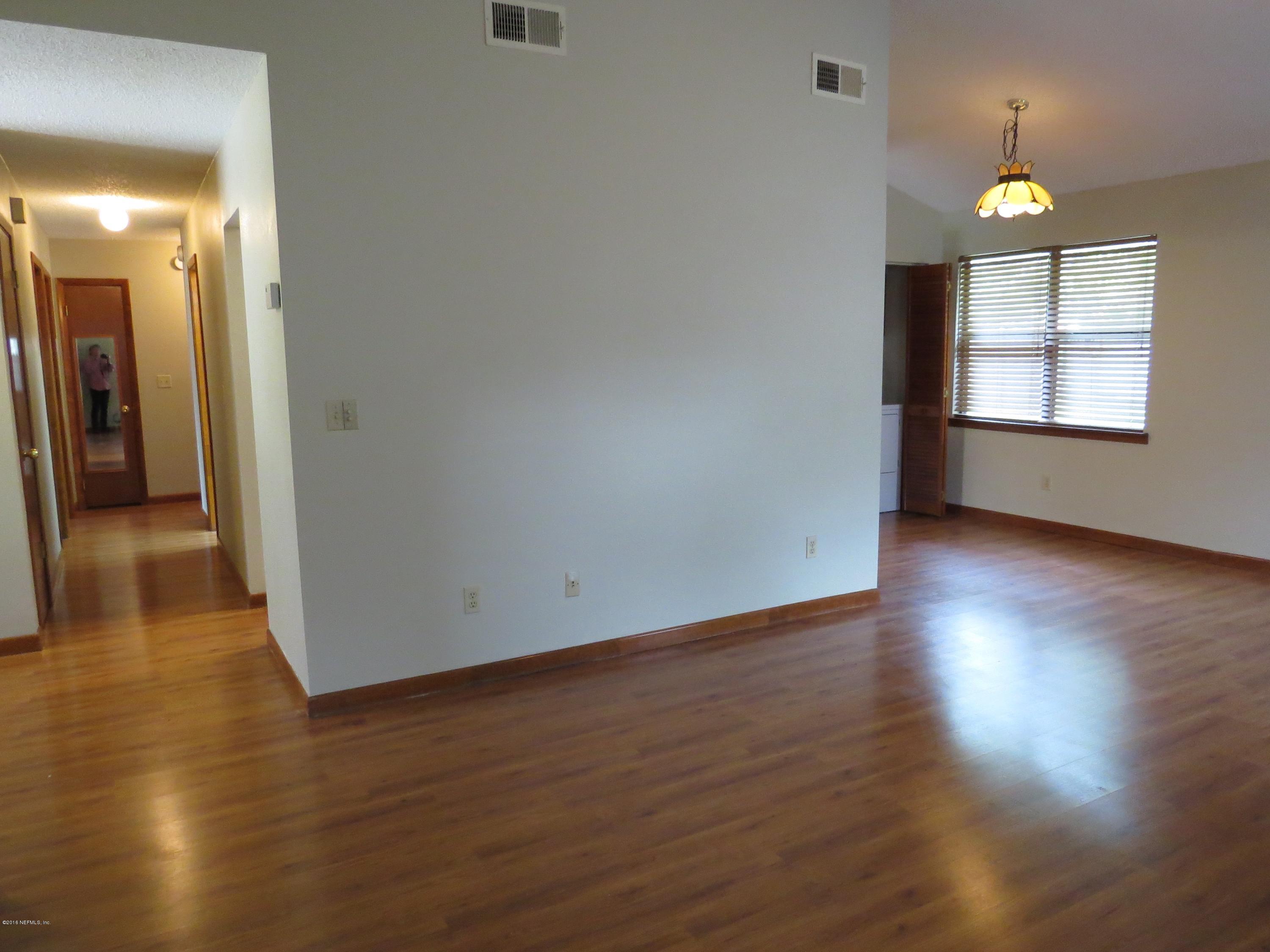 12770 Beaubien Road Jacksonville, FL 32258 - Photo 10 of 46 an empty room with wooden floor and windows