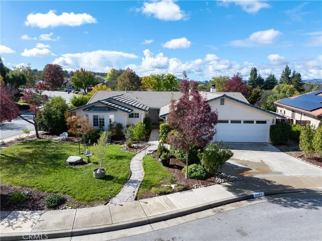 a front view of house with a garden