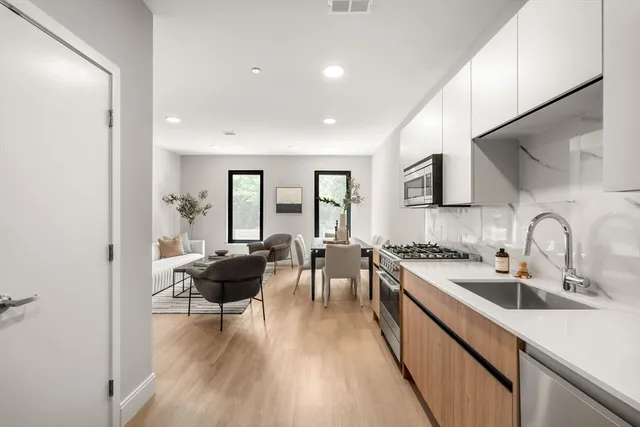 a kitchen with sink stove and cabinets
