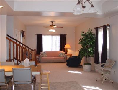 843 West Simmons Road Tucson, AZ 85705 - Photo 2 of 10 a living room with furniture a chandelier and a flat screen tv