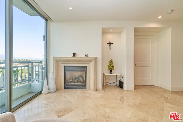 a view of a livingroom with a fireplace and bathroom