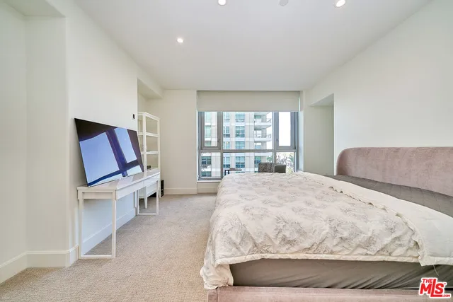 a living room with a balcony furniture and a large window