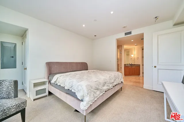 a bedroom with a bed and a couch