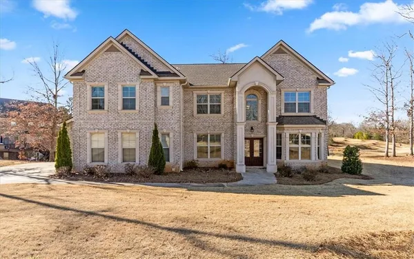 a front view of a house with a yard