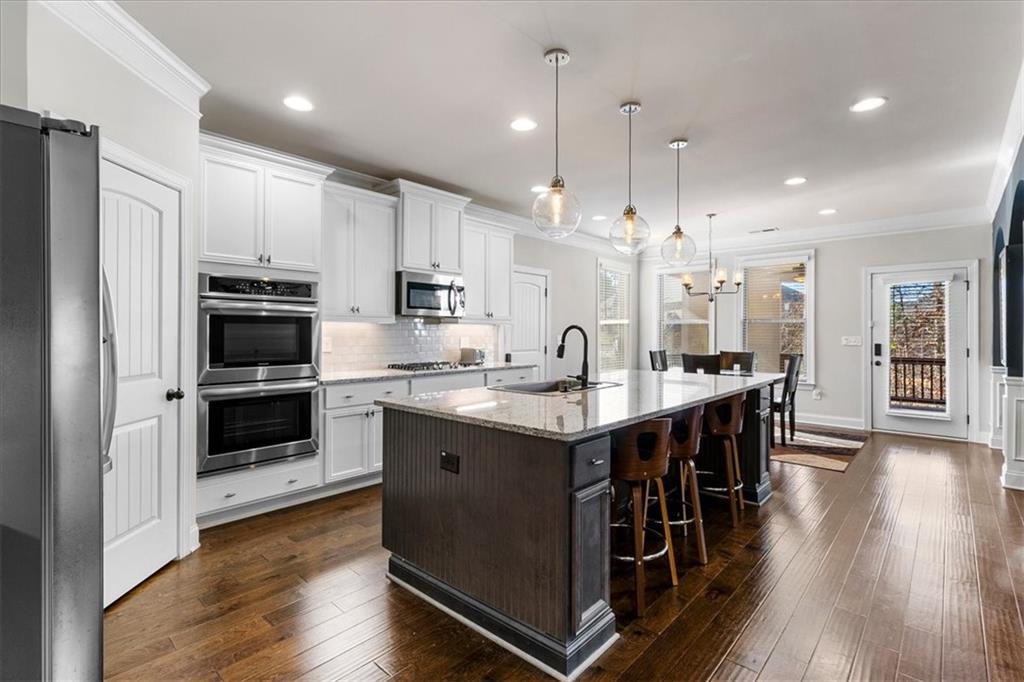 191 Crystal Lake Boulevard Hampton, GA 30228 - Photo 19 of 68 a large kitchen with stainless steel appliances a large counter top a stove a sink and a refrigerator