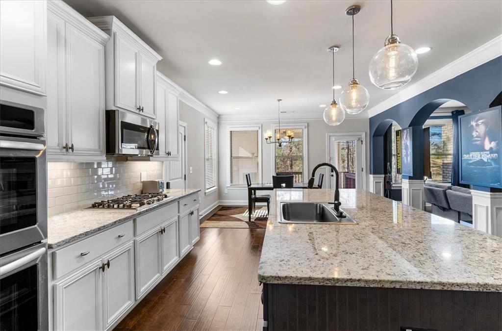 191 Crystal Lake Boulevard Hampton, GA 30228 - Photo 22 of 68 a large kitchen with granite countertop a stove a sink a oven a dining table and chairs