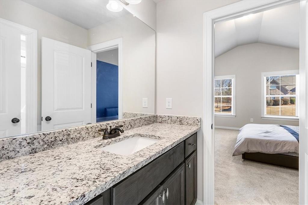 191 Crystal Lake Boulevard Hampton, GA 30228 - Photo 39 of 68 a spacious bathroom with a granite countertop sink and a mirror