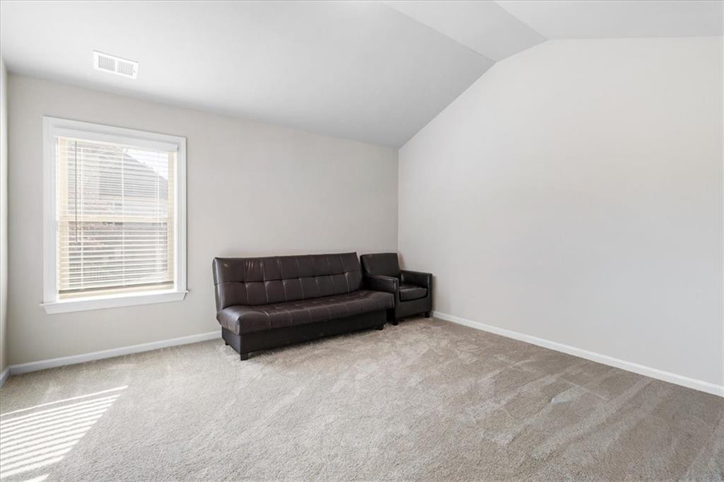 191 Crystal Lake Boulevard Hampton, GA 30228 - Photo 41 of 68 a living room with a couch and a window