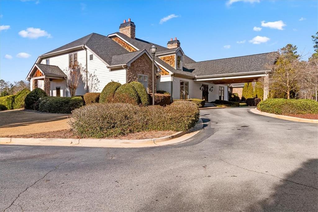 191 Crystal Lake Boulevard Hampton, GA 30228 - Photo 60 of 68 a front view of a house with a yard and garage