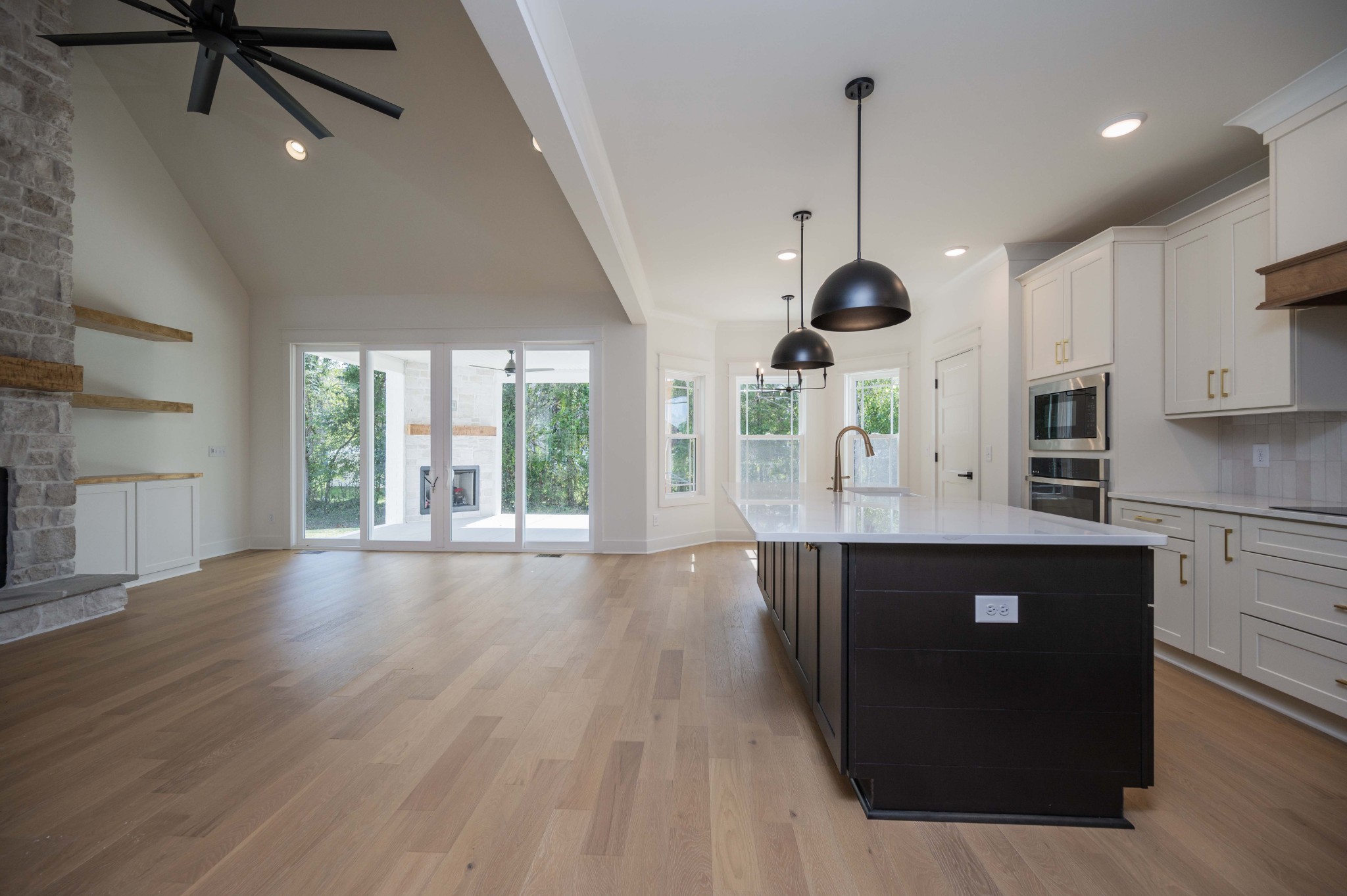 4 Holly Grove Road Lascassas, TN 37085 - Photo 16 of 37 a kitchen with stainless steel appliances granite countertop a refrigerator a sink dishwasher a stove and white countertops with wooden floor