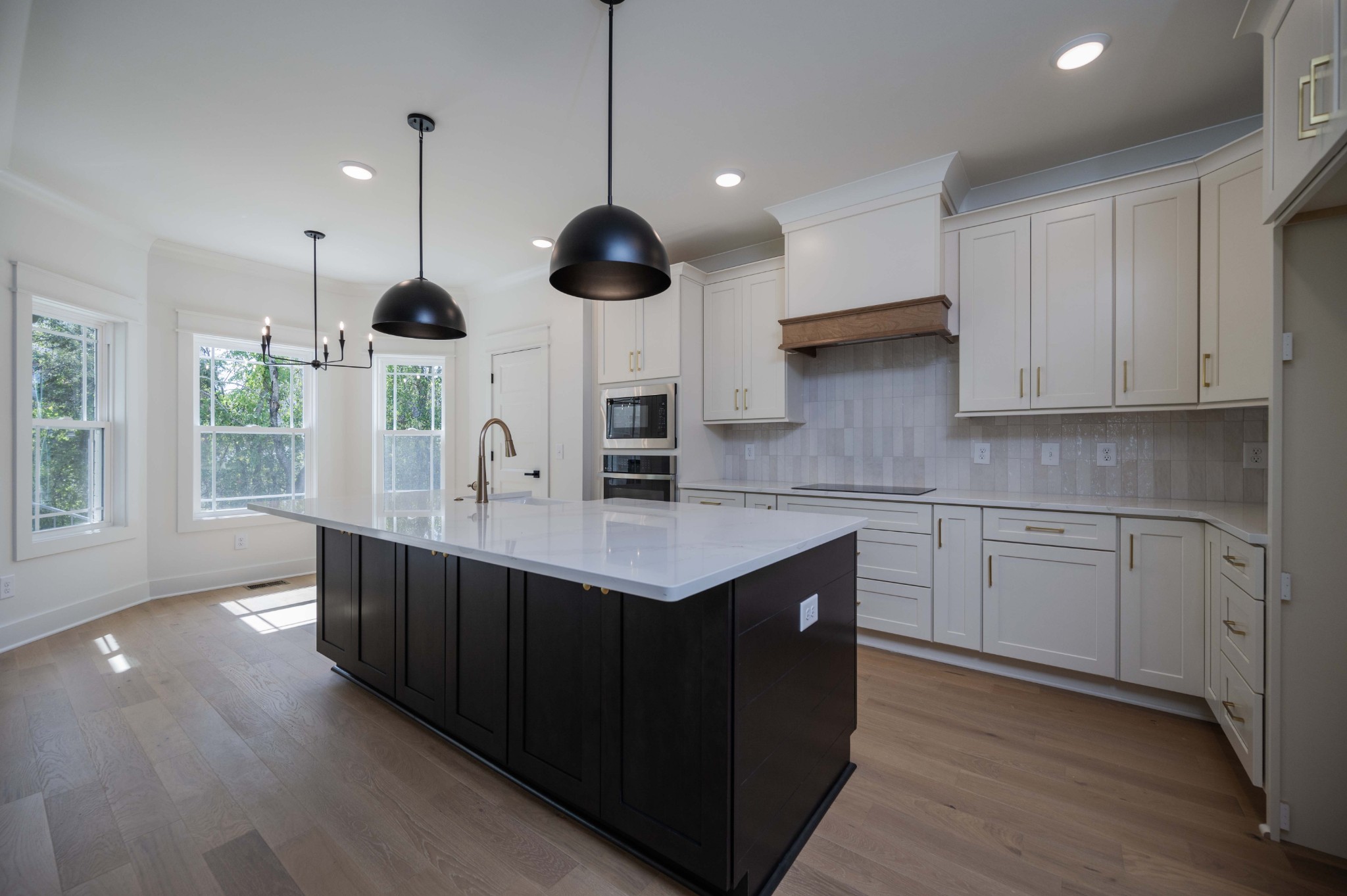 4 Holly Grove Road Lascassas, TN 37085 - Photo 17 of 37 a kitchen with stainless steel appliances granite countertop a sink a oven and a large window with wooden floors