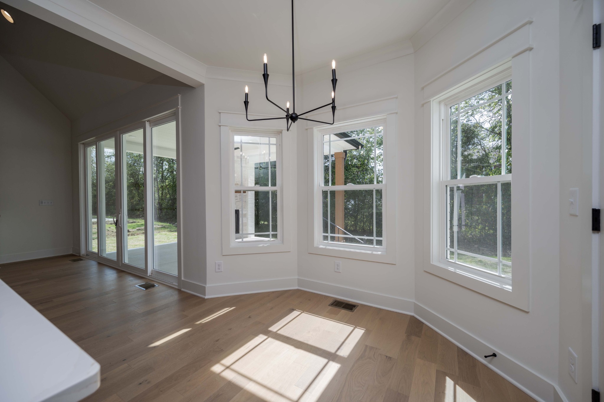4 Holly Grove Road Lascassas, TN 37085 - Photo 18 of 37 a view of an empty room with windows and chandelier