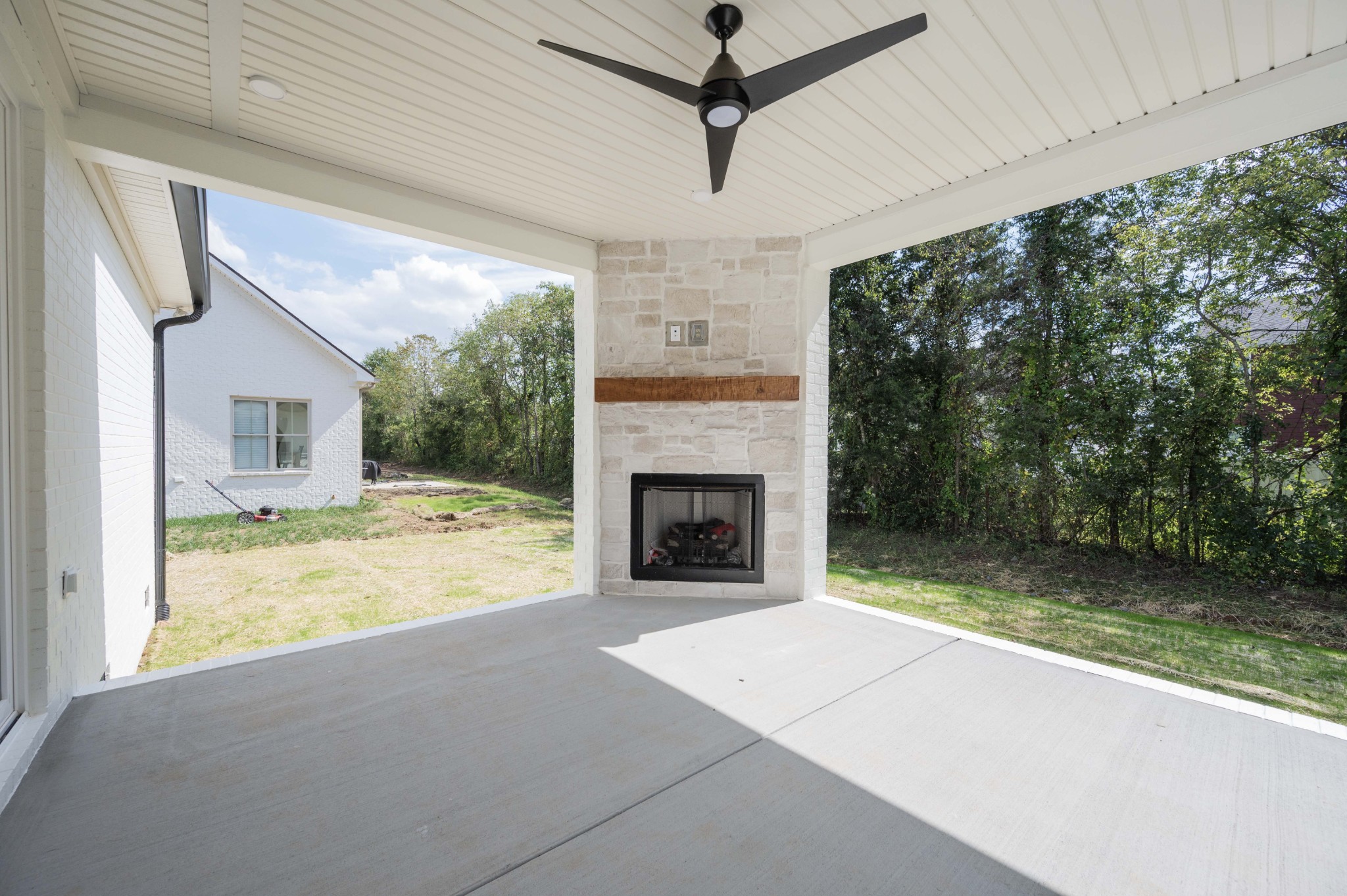 4 Holly Grove Road Lascassas, TN 37085 - Photo 36 of 37 a view of a livingroom with a fireplace a ceiling fan and windows