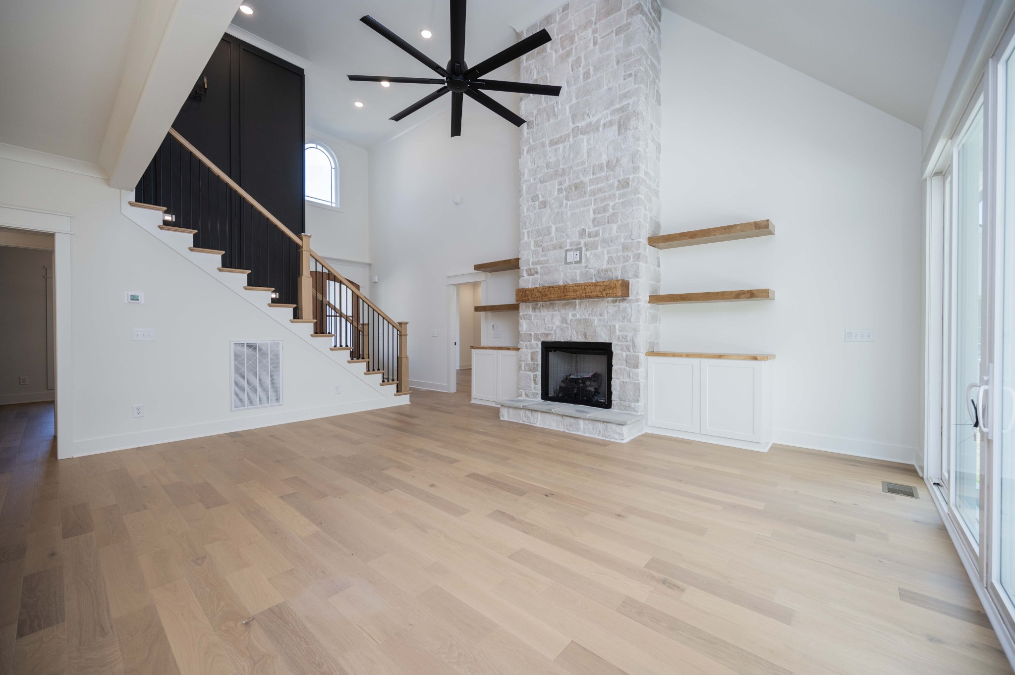4 Holly Grove Road Lascassas, TN 37085 - Photo 8 of 37 a view of an empty room with wooden floor and a fireplace