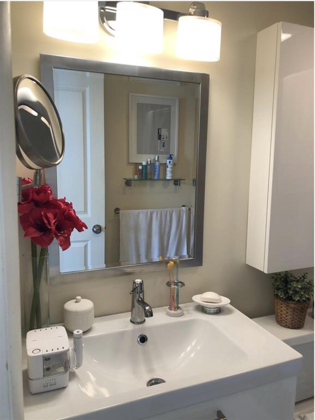 1951 Northeast 39th Street Northeast, Unit 249 Lighthouse Point, FL 33064 - Photo 14 of 23 a bathroom with a sink vanity and mirror