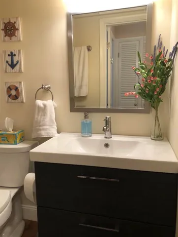 a bathroom with a sink a toilet and mirror
