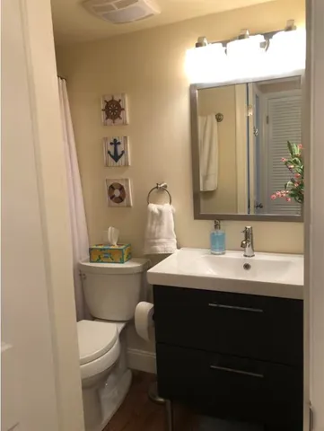 a bathroom with a sink toilet and mirror