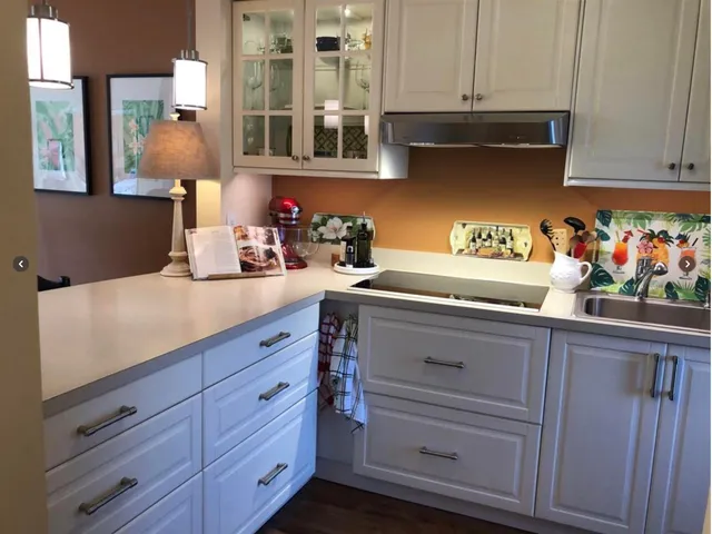 a kitchen with cabinets and window