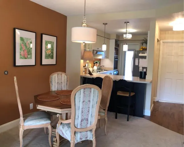 a dining room with furniture and window