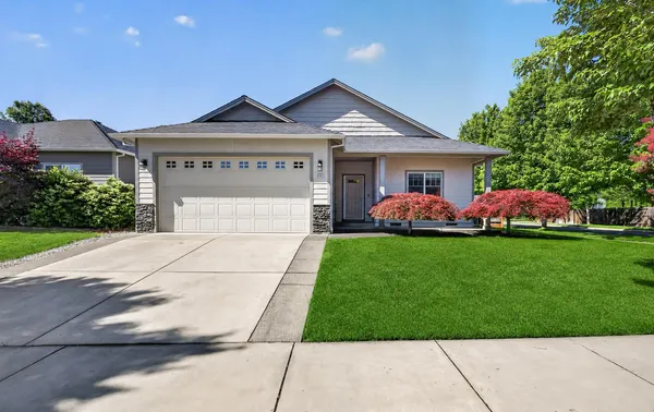 a front view of house with yard and green space