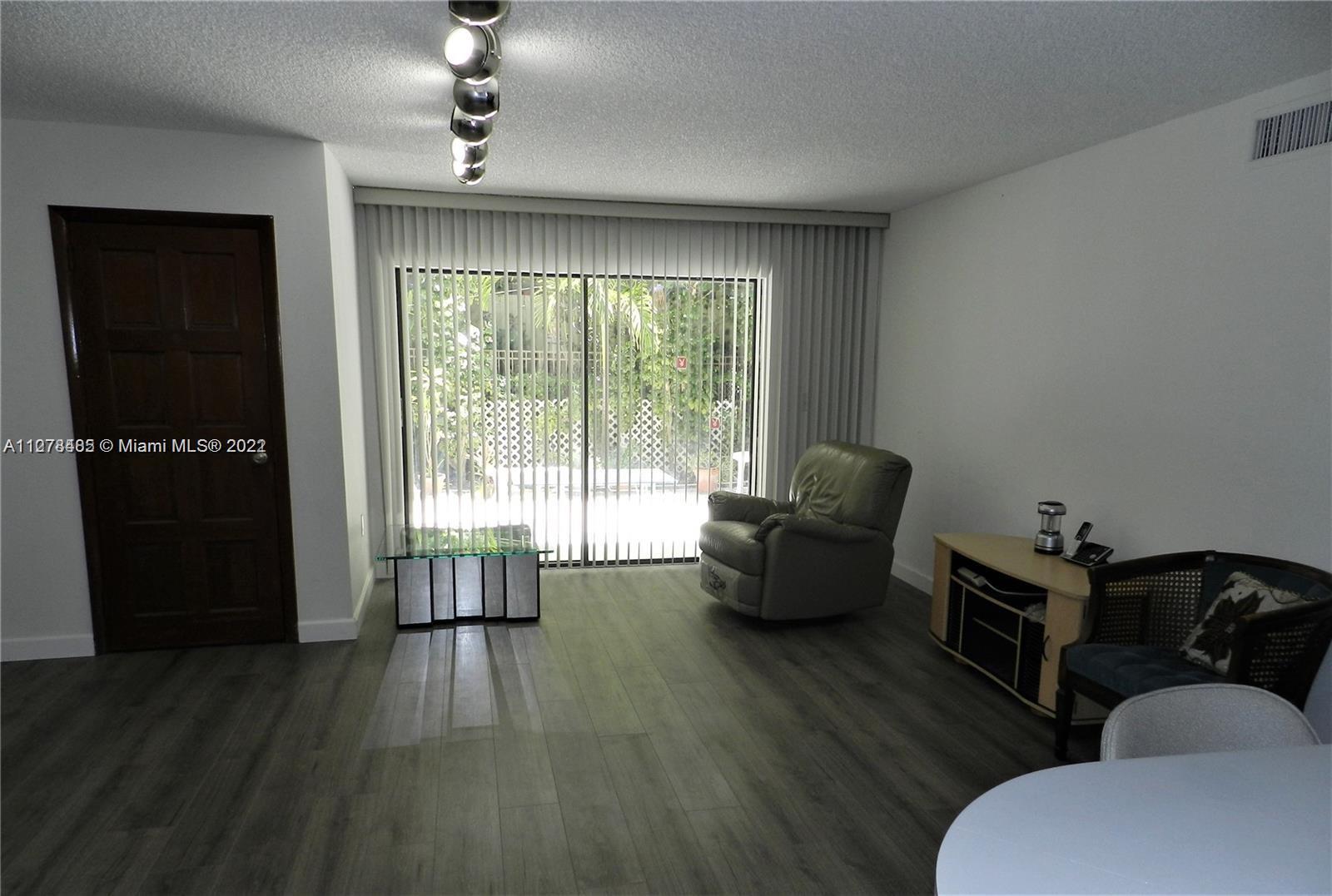8927 Harding Avenue Surfside, FL 33154 - Photo 17 of 22 a living room with furniture and wooden floor