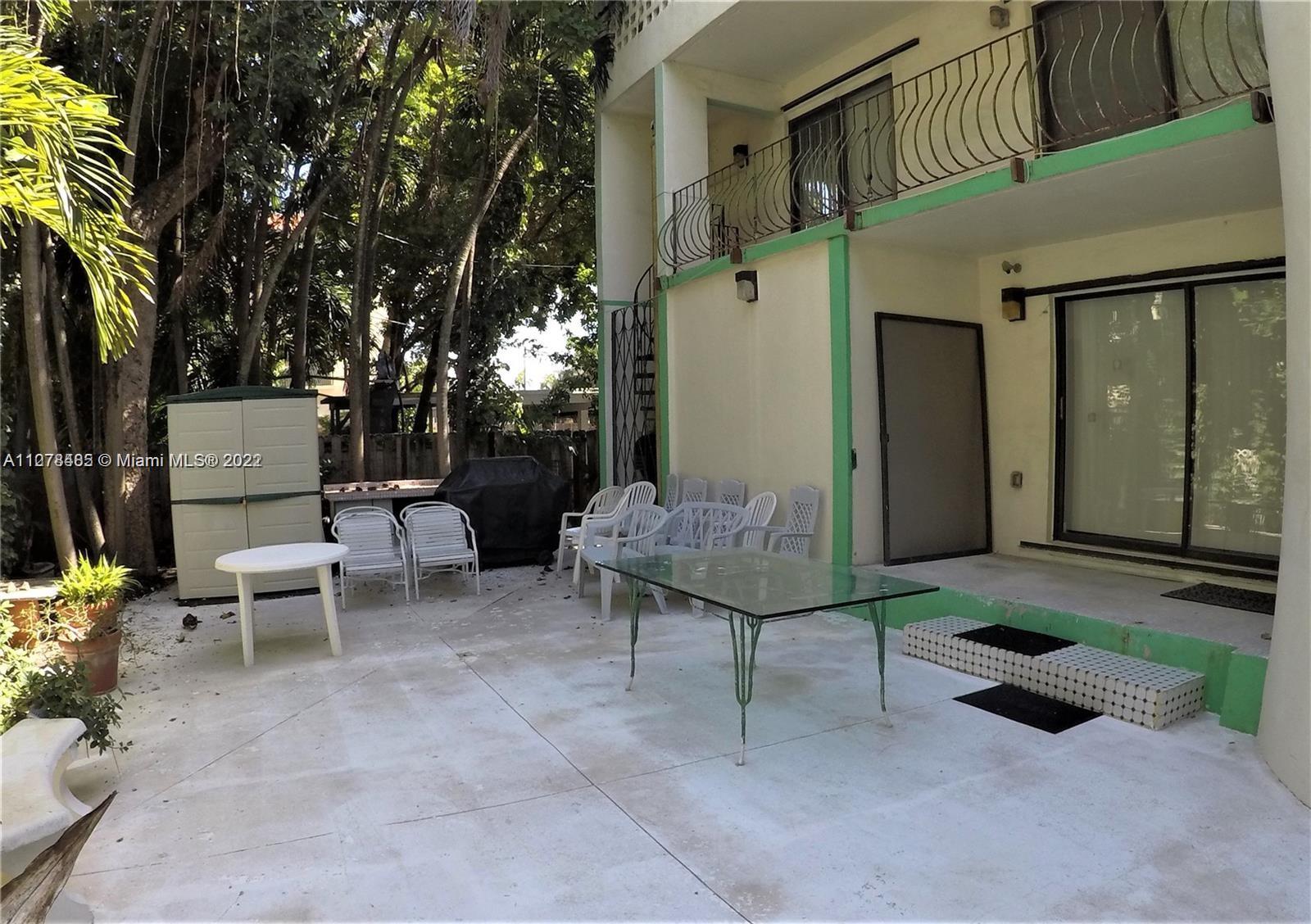 8927 Harding Avenue Surfside, FL 33154 - Photo 18 of 22 a backyard of a house with outdoor seating