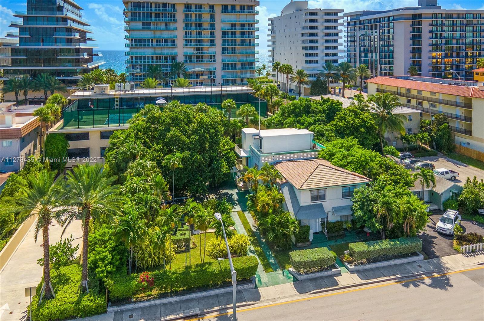8927 Harding Avenue Surfside, FL 33154 - Photo 2 of 22 a aerial view of a house with a garden and plants