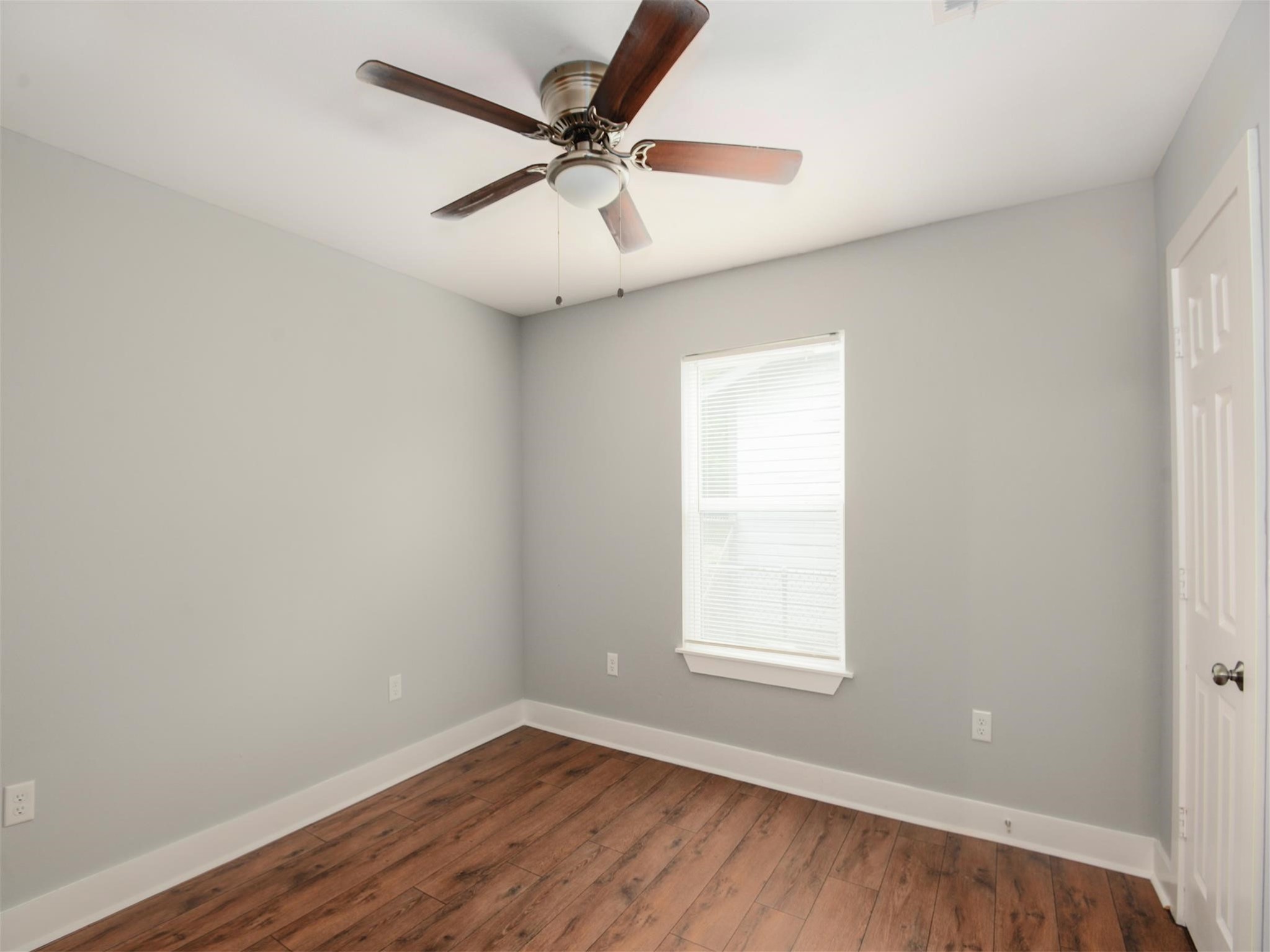 7815 Jester Street Houston, TX 77051 - Photo 14 of 22 an empty room with wooden floor ceiling fan and window