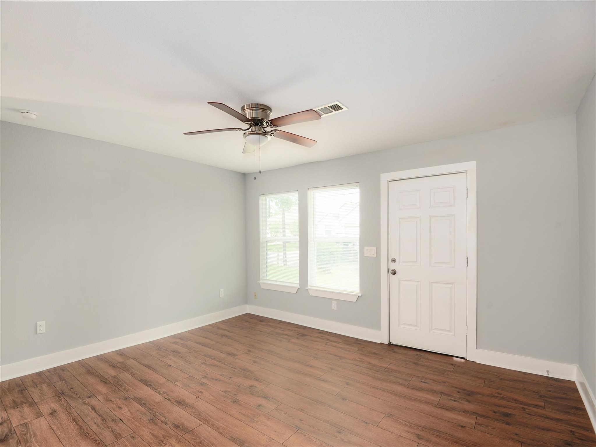 7815 Jester Street Houston, TX 77051 - Photo 6 of 22 a view of an empty room with wooden floor and a window