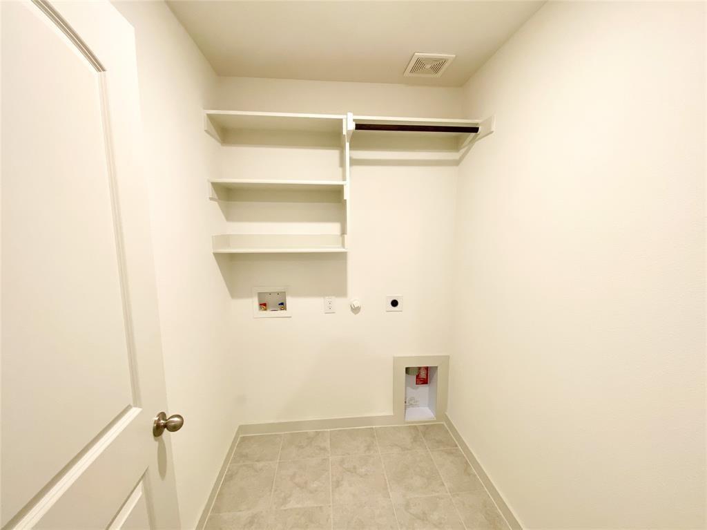 1372 Cedar Street Forney, TX 75126 - Photo 11 of 13 Washroom with electric dryer hookup, washer hookup, light tile patterned floors, and gas dryer hookup
