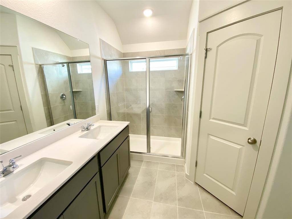 1372 Cedar Street Forney, TX 75126 - Photo 8 of 13 Full bath with a shower stall, light tile patterned floors, double vanity, and vaulted ceiling