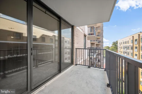 a view of balcony with floor to ceiling window