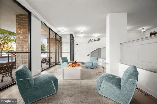 a living room with furniture and large windows