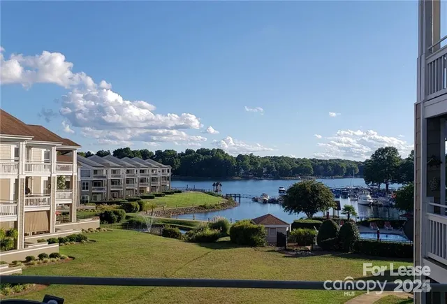 a view of a lake with lawn chairs