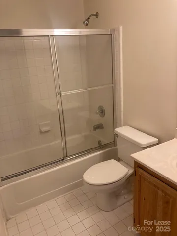 a white toilet sitting next to a bath tub
