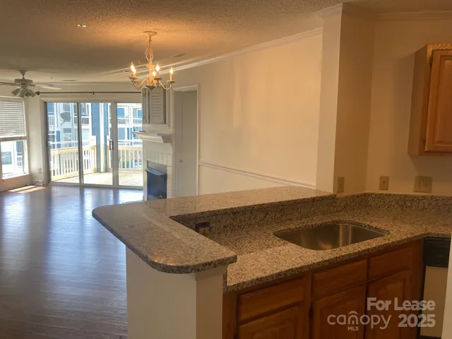 a kitchen with a sink a counter top space and cabinets