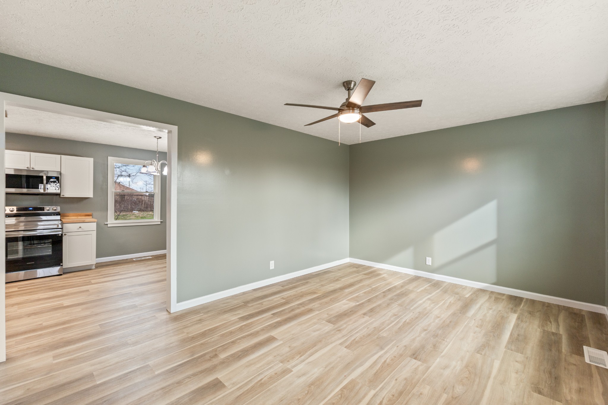 7109 King Road Fairview, TN 37062 - Photo 12 of 26 a view of a big room with wooden floor and kitchen view